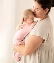 pink baby swaddle mum holding baby