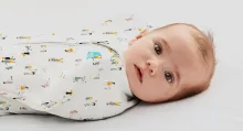Baby in "Community print" swaddle