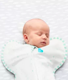 baby asleep in green swaddle